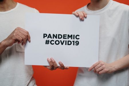 people-holding-white-paper-with-pandemic-covid19-text-3952234